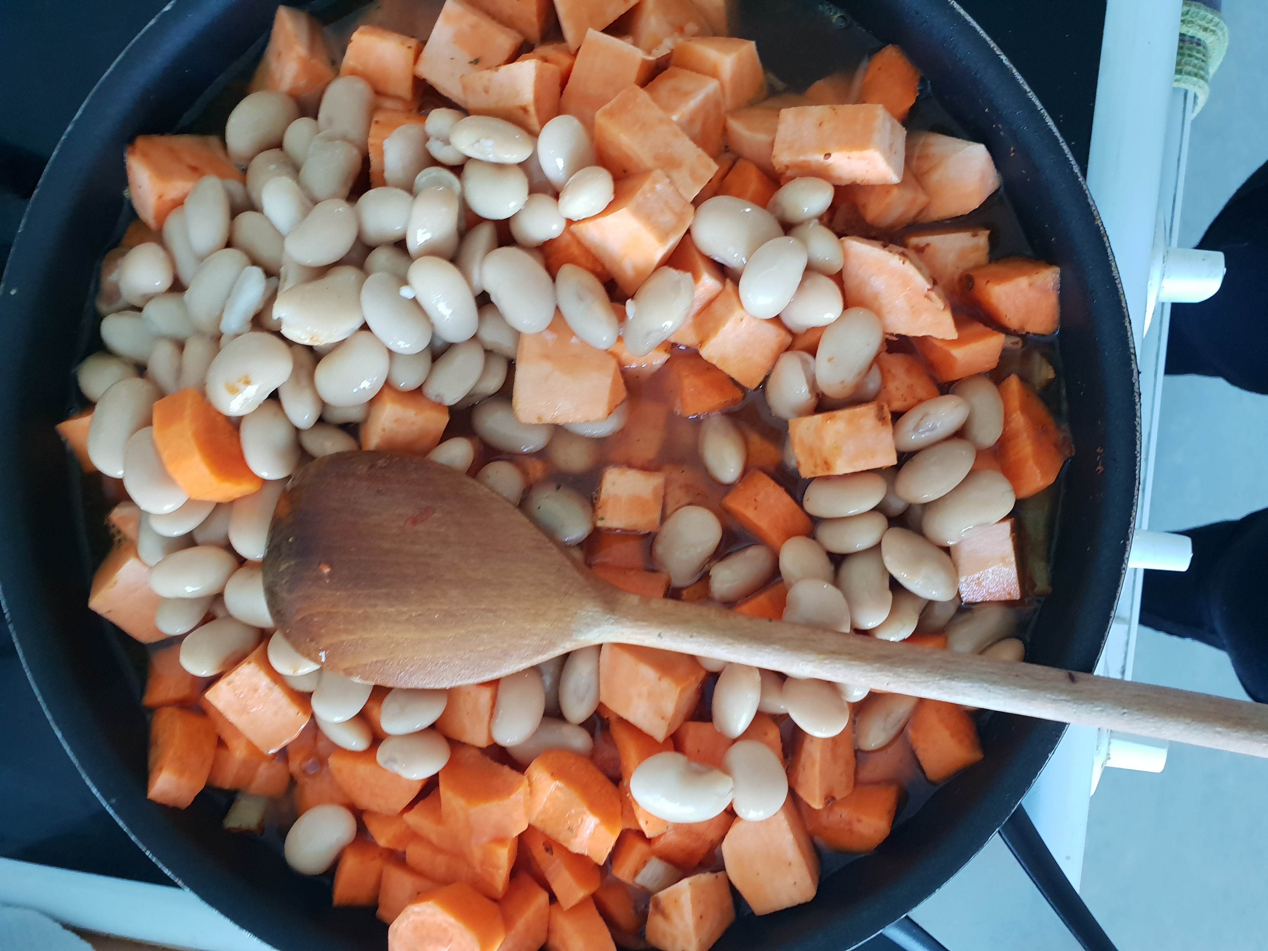 Adding tubers and beans to the dish